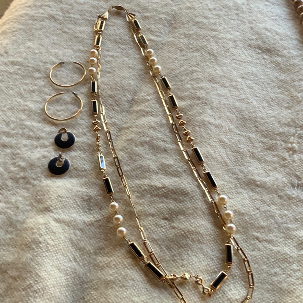 Gold chain and pearl bead necklace with gold hoops and black and gold earrings